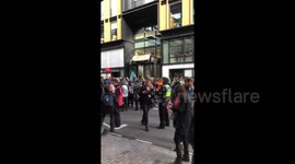 Extinction Rebellion activists climb the entrance of London's YouTube HQ