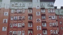 Eerie sight of abandoned building with hundreds of smiling portraits