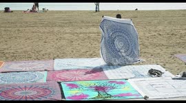 people selling sarongs on the beach, barcelona