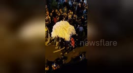 Catalan protestors carry away a large stack of toilet paper in Barcelona