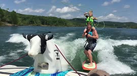 7 year old cowboy ropes steer while wakesurfing on dad's shoulders