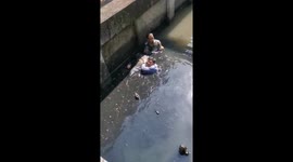 Passersby leap into filthy canal to save unconscious man from drowning in Thailand