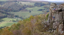Time-lapse two rock climbers climbing Chequers Buttress in autumn on Froggatt Edge, Peak District, Derbyshire