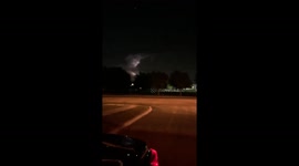 Lightning illuminates outline of tornado above Dallas