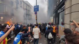 Violent protesters united chant as they confront riot police at firey barricade