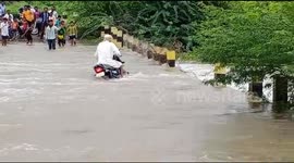 Terrifying moment biker is washed away by flood in India