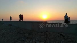 French Tourists Walks Along Side In Sunset Orange View