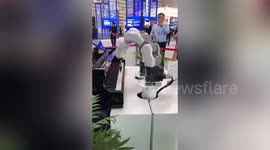 Robotic arms supported by 5G play classic Chinese ballad on piano