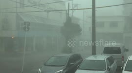 Powerful wind blows debris and sheets of rain through air during Typhoon Lingling