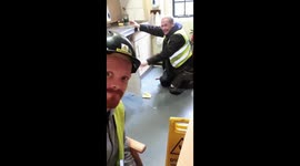 Plumber attempts to defrost freezer with screwdriver much to the disapproval of his colleague