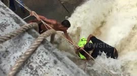 Dramatic moment of teenage boy rescued from reservoir dam in Thailand