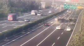 Transport truck flips over trying to avoid stalled car on Chinese highway
