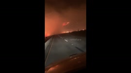 US WILDFIRES: Smoke shrouds California highway as Tick Fire rages