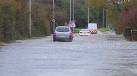 UK drivers make way through flooded road in Yorkshire