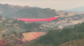Aircraft drops fire retardant on Kincade fire in Sonoma County, California