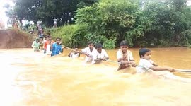 Children risk lives to cross flooded river just to get to school