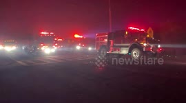 Dozens of fire trucks arrive to tackle spreading California fire