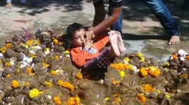 Parents in north India toss their children into cow dung for good luck on religious holiday