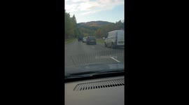 Angry driver stops cars overtaking by driving in middle of both lanes.