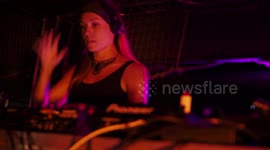 cool female dj perforning at outdoor party in barcelona