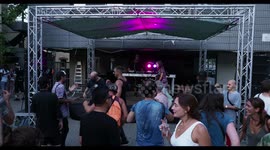 cool female dj perforning at outdoor party in barcelona