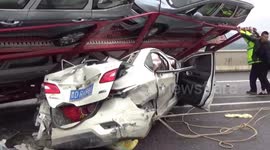 People in car luckily survive after transport truck flattens the vehicle in China