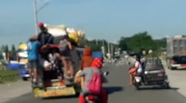 Teenagers Ride Overloaded Jeepneey In The Philippines