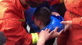 Chinese firemen free boy's head from children's spittoon