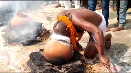 Hindu mystic bathes with boiling milk and throws it onto his disciples