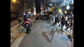 Hong Kong Protesters masked for Halloween escape from police tear gas