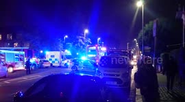 Police escort patient from serious fire in South London