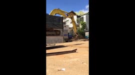 The way the excavator driver moving the excavator down from the truck without using a crane