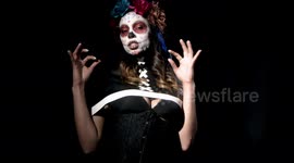 woman dancing with dia de los muertos/day of the dead makeup
