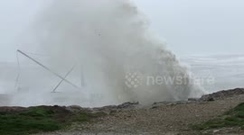 Huge waves crash against rocks at Portland Bill in Dorset, England
