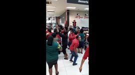Shop workers celebrating Rugby World Cup victory in SA