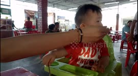 Funny baby refusing to eat by showing TAI CHI hands