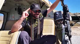 Dude is pumped to let rip with an automatic machine gun from a chopper over Nevada desert