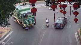 Chinese cyclist miraculously survives being run over by truck