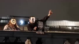 Londoners in Guy Fawkes masks gather to support Julian Assange