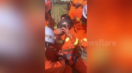 Exhausted firefighter faints after climbing into deep well to rescue trapped man in China