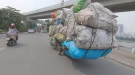 Seriously overloaded tricycle spotted in Viet Nam! Overload tricycles carrying dozens of giant sacks