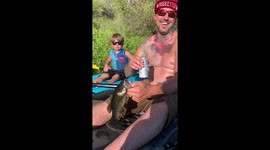 Son freaks out when he catches a fish on his kayak and almost flips over