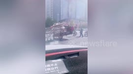 Chinese motorist drives overloaded three-wheeler with front tyre off the ground