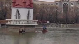 University security guards rescue black swans trapped on frozen lake in China