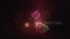 Fireworks display in night sky, with sound