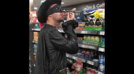Mysterious masked prankster swallows hot dog off supermarket shelf