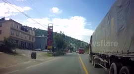 Tyres smash into car after falling off semi-trailer truck in China