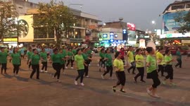 Enormous quantity of ladies dance traditional Thai dance at the streets of Chiang Mai Thailand
