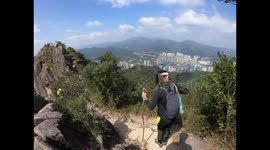 Barefoot hikers climb the Lion's rock, the iconic rock formation of Hong Kong
