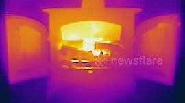 Thermal Image video of a log burning stove with a real flame fire burning on a cold frosty winters morning in Wirksworth, Derbyshire, UK